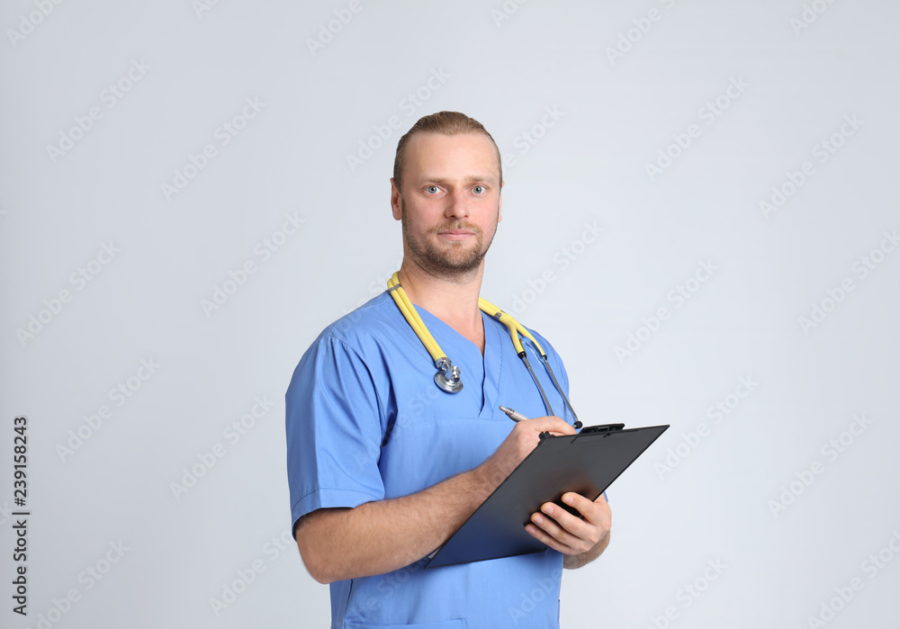 Portrait of medical assistant with stethoscope and clipboard on color background Portrait of medical assistant with stethoscope and clipboard on color background