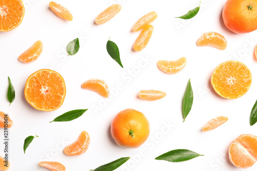 Composition with tangerines and leaves on white background  top view