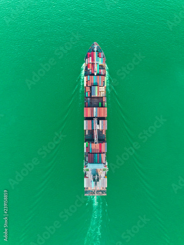 Aerial top view container ship on the sea full speed transport container for logistics import export or shipping background. © Pawinee