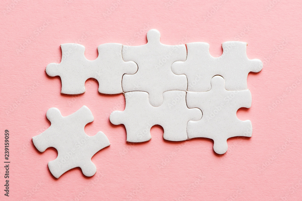 White details of puzzle on a pink background White details of puzzle on a pink background