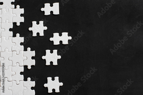 White details of puzzle on black background. With copy space