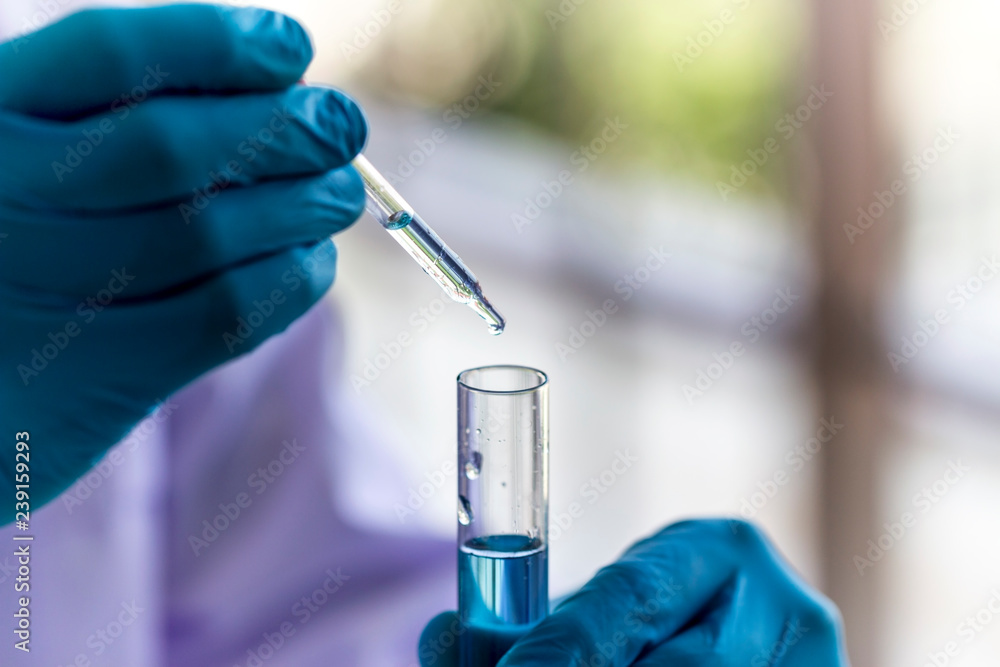 science research concept, scientist is dropping chemical liquid to test tube science research concept, scientist is dropping chemical liquid to test tube