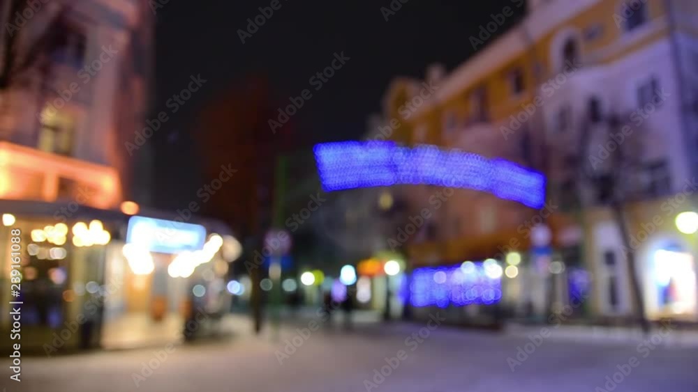Snow covered Christmas tree with colored lights at night in the city. Snowfall Snow covered Christmas tree with colored lights at night in the city. Snowfall