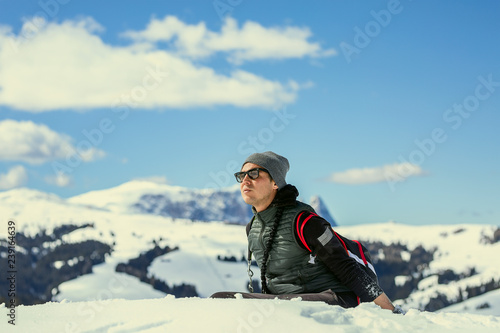 Man in winter clothes enjoys the snow.