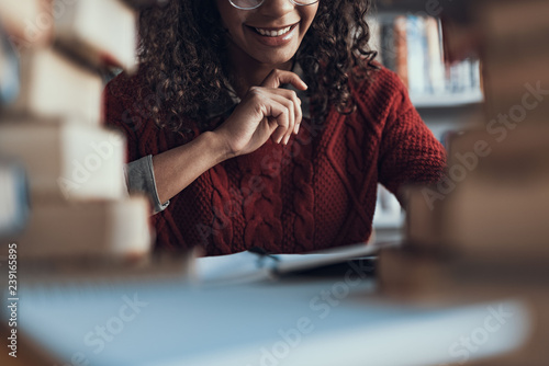 Close up of happy student sitting at the table and smiling