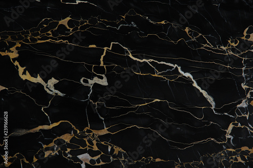Фотография Yellow veins on black polished natural marble Nero Portoro