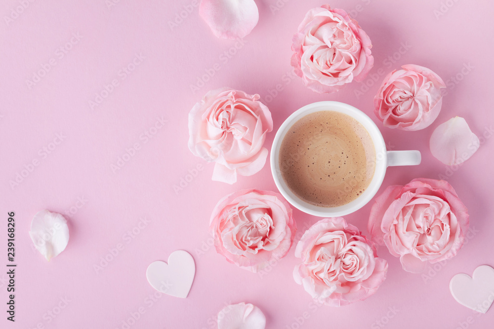 Morning coffee and beautiful rose flowers on pink pastel table top view.  Cozy breakfast for Womens or Valentines day. Flat lay. Stock Photo