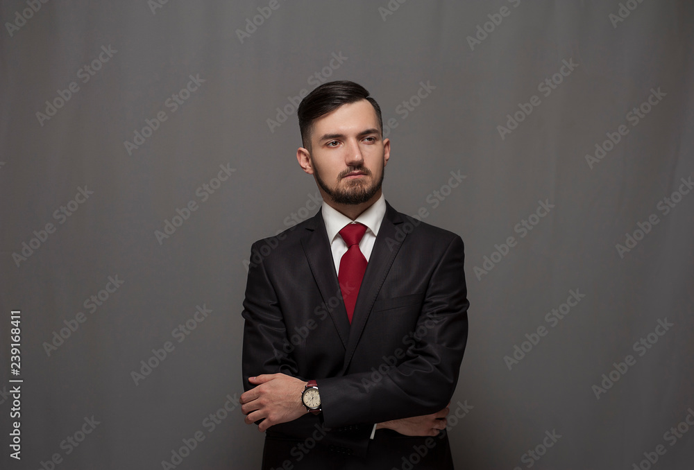 Portrait of serious confident businessman posing against gray background Portrait of serious confident businessman posing against gray background