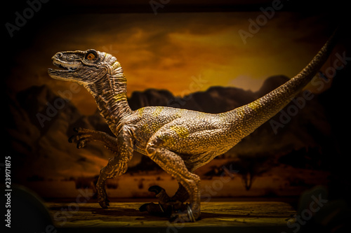 Fototapeta Naklejka Na Ścianę i Meble -  show case, realistic dinosaurs plastic toy in the box on the shelf. Low key dark light.