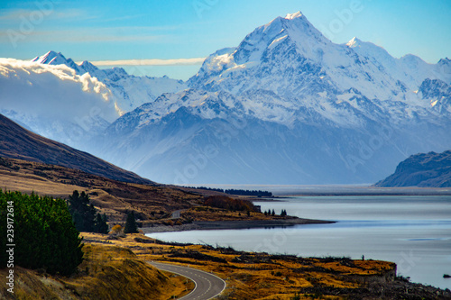 Aoraki/Mount Cook, road and turquoise lake Pukaki view from Peter´s Lookout, South Island, New Zealand. Warm colours, clear sky, snowy mountain tops. Iconic scenic New Zealand photo. Must visit place!