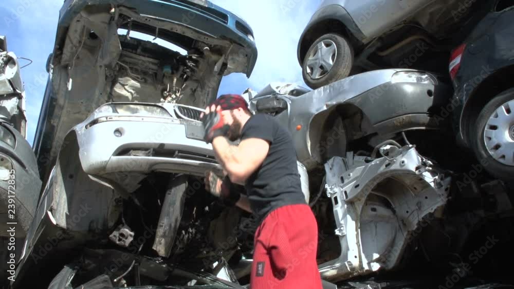 A young fighter is training in martial arts at a junkyard (slow motion) FDV A young fighter is training in martial arts at a junkyard (slow motion) FDV