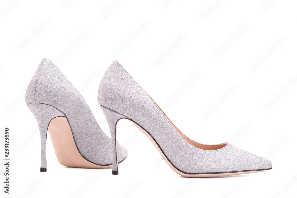Silver high-heeled shoes. Female shoes on a white background. Silver high-heeled shoes. Female shoes on a white background.