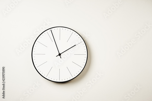 Classic round wall clock on a white background with copy space