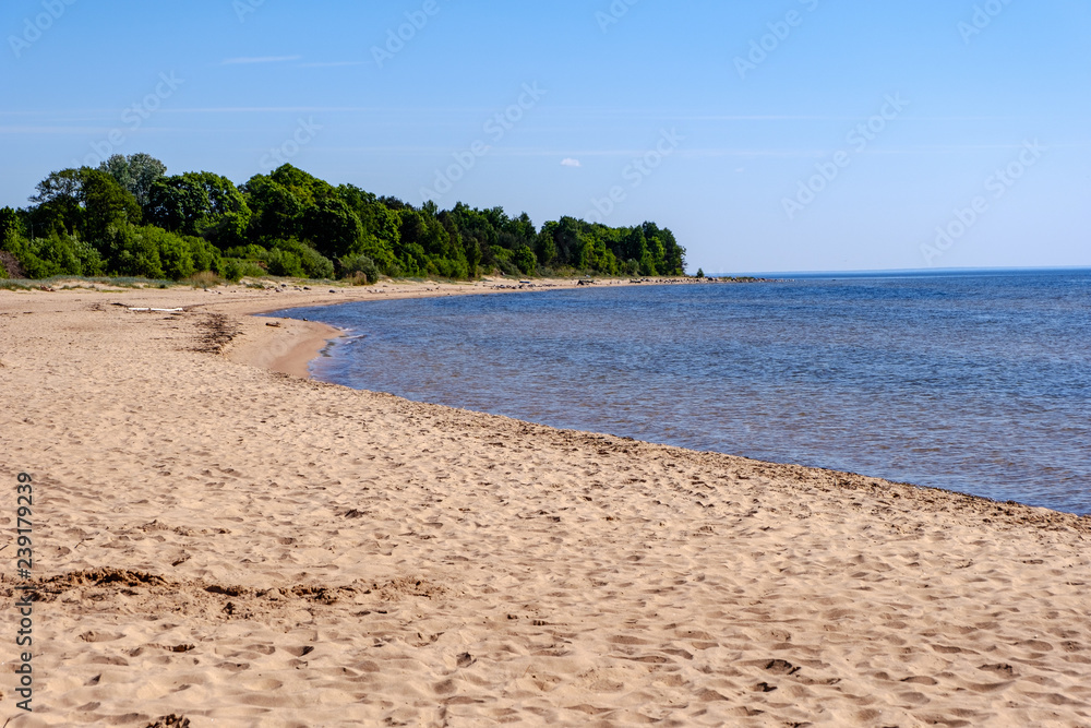 lakeside beach details with sand, rocks and blur background