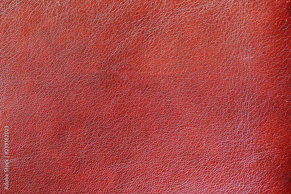 Fototapeta premium Texture of genuine leather spotted, painted, with wrinkle, crease, red brown color, background surface