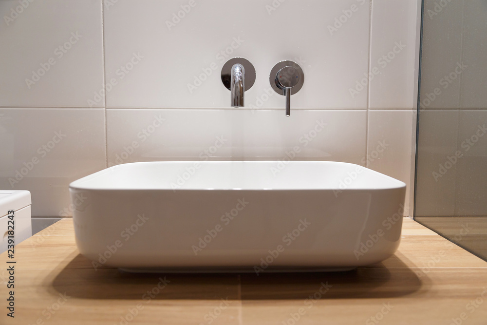 Fototapeta premium Sink and wall-mounted washbasin mixer