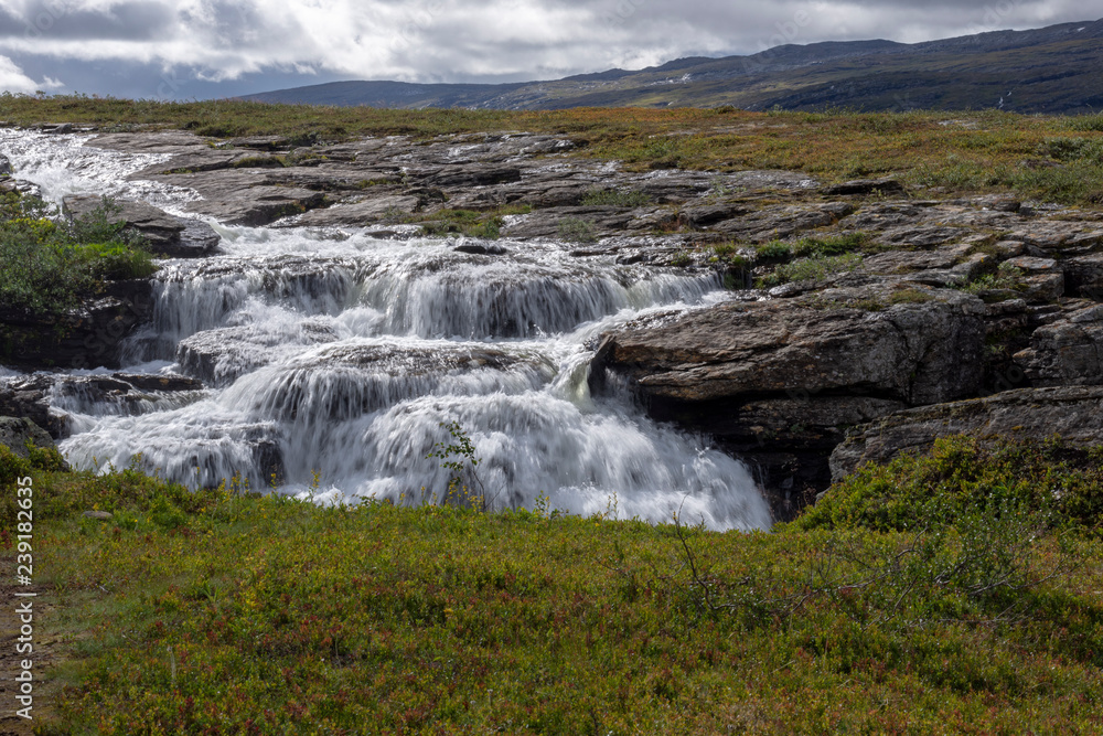 Fototapeta premium White water down a flat cliff in Norway.