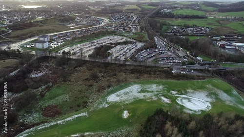 Fast motion low level aerial footage of traffic at  Croy railway station on the Glasgow to Edinburgh line. photo