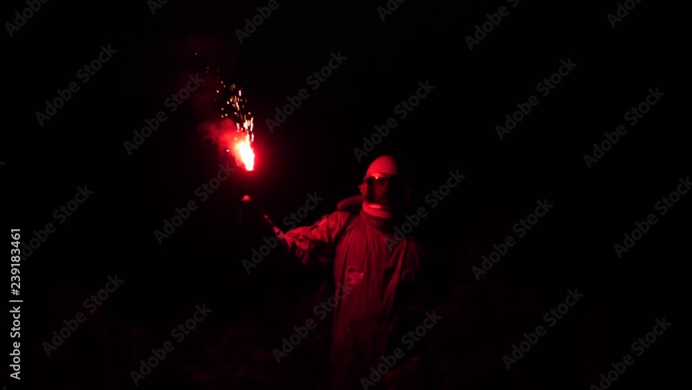 In the dark astronaut spins, with his red light in his hand. The astronaut goes through the high grass 4K Slow Mo In the dark astronaut spins, with his red light in his hand. The astronaut goes through the high grass 4K Slow Mo