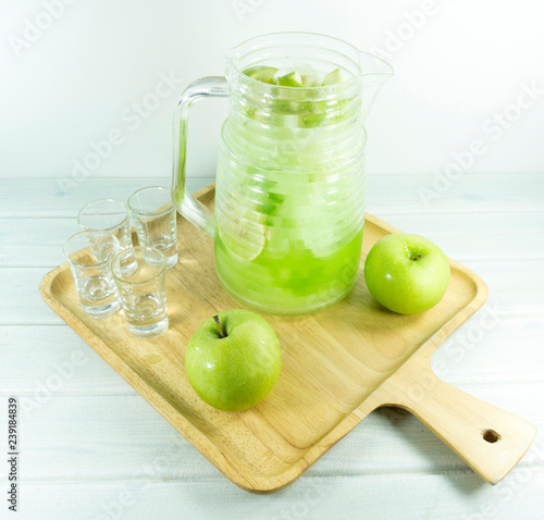 Cocktail Apple Italian soda in a glass jug on a on white background.