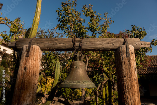 Bell in courtyard of San Juan Bautista mission , California, USA.