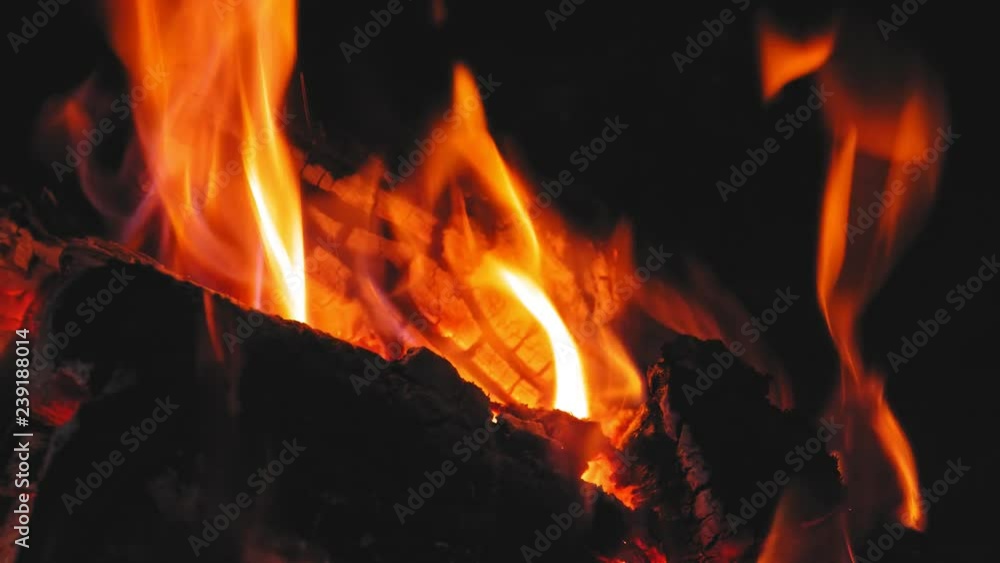 Close-up shot of warm cozy burning fire in a brick fireplace. 4K Close-up shot of warm cozy burning fire in a brick fireplace. 4K