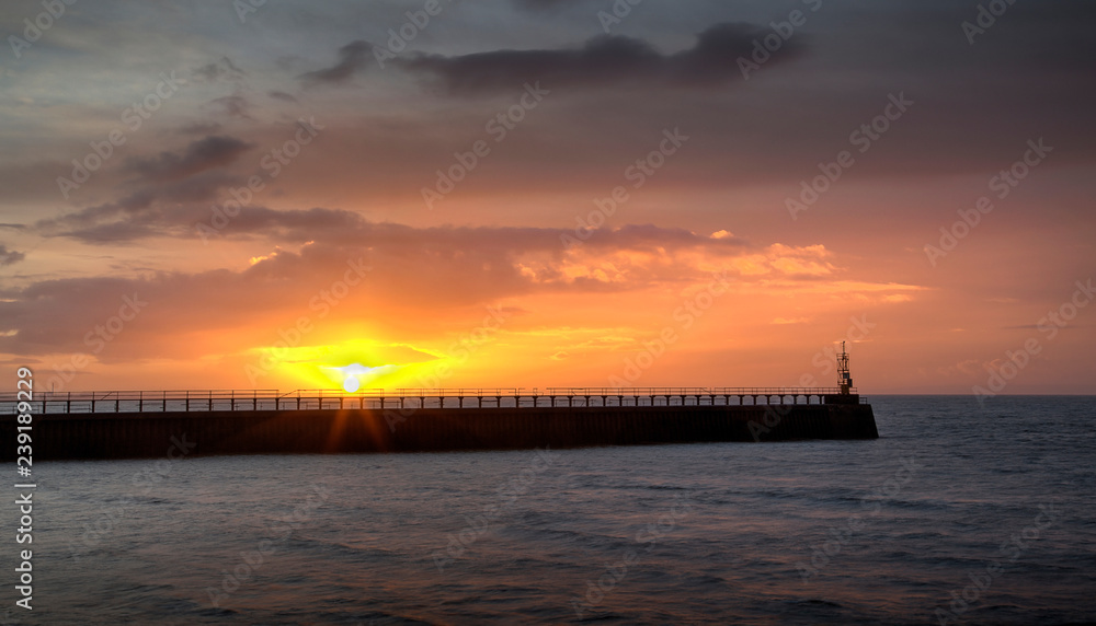 Sunrise at the east pier and mouth of the river Tawe at the entrance to the docks at Swansea city, Wales UK Sunrise at the east pier and mouth of the river Tawe at the entrance to the docks at Swansea city, Wales UK