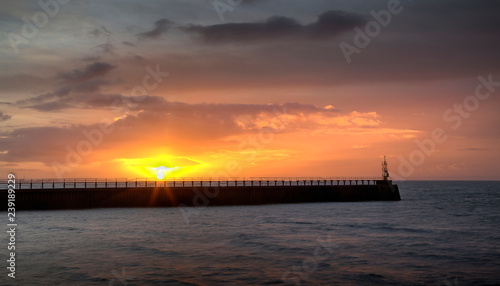 Sunrise at the east pier and mouth of the river Tawe at the entrance to the docks at Swansea city  Wales UK