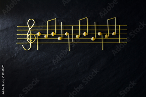 Musical Christmas sheet music paste isolated on a black textural background.