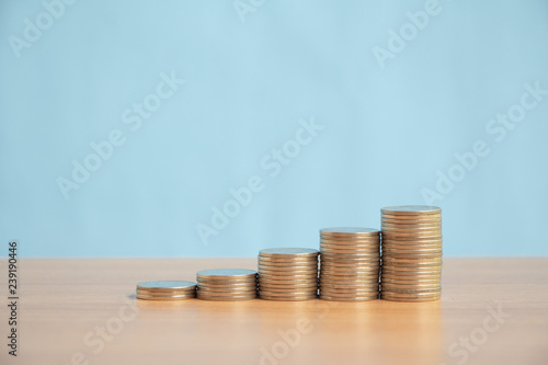 Stack of coins on wood table .saving money or growing business concept.