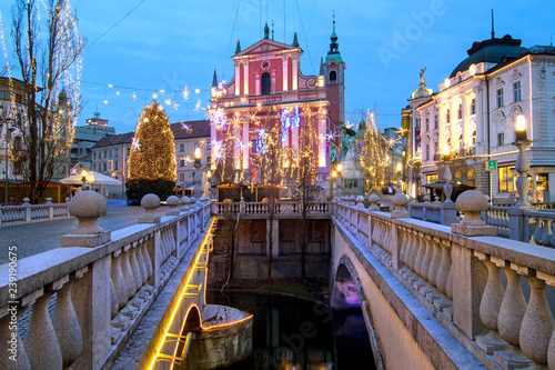 Triple bridges, Christmas tree on Preseren's square and Franciscan church, illuminated for Christmas and New Year's celebration, Ljubljana, Slovenia photo