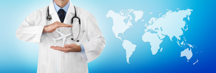 travel medical insurance concept, doctor's hands protect an airplane on blue background with world map, web banner template