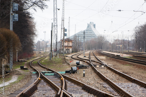 Railway road intersection with building in background.