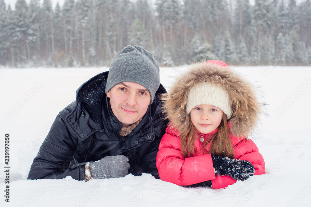 Happy family of dad and kid enjoy winter snowy day