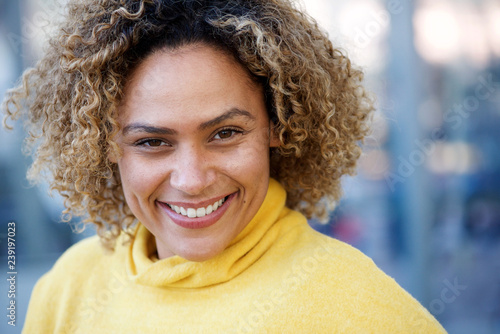 Close up happy african american woman with curly hair