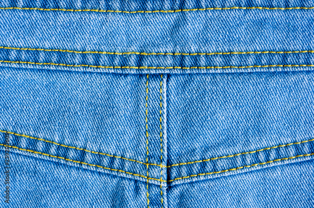 Blue washed faded jeans texture with seams