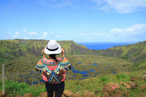 One Female Appreciating the Breathtaking View of Rano Kau Crater Lake from Orongo Ceremonial Village on Easter Island with Pacific Ocean in the Distance, Chile 