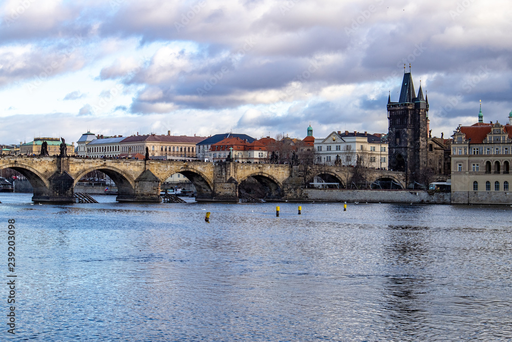 Obraz premium Prague, Czech Republic, Europe, panorama overlooking the historic buildings of Prague Castle, Charles Bridge and the Vltava River in front of interesting blue sky with clouds