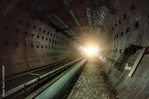 Round tiled tunnel in abandoned underground nuclear physics laboratory