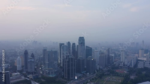 Wallpaper Mural JAKARTA, Indonesia - December 12, 2018: Beautiful aerial view of misty morning with silhouette of skyscrapers in Jakarta downtown. Shot in 4k resolution Torontodigital.ca