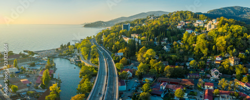 Panoramic view of the sea, road, mountains. Evening light. Sunset over the sea. Aerial photography with quadrocopter. Sochi resort of Russia.