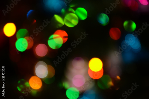 Bokeh. Christmas tree lights. Holiday background. Garland. Glitter. Christmas eve. Defocused sparkles. New Year backdrop. Blinks. Carnival. Bokeh retro style photo.