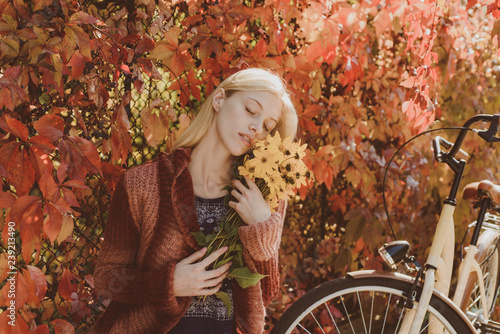 Autumn fashion concept. Cute girl in good mood posing in autumn day. Autumn woman. Autumn trend and vogue.