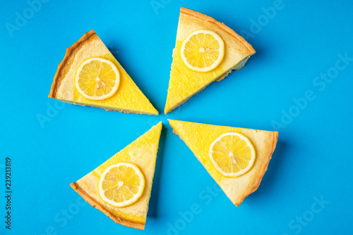 Delicious lemon pie slices on a blue background. Homemade sweet food. Minimalist style. photo