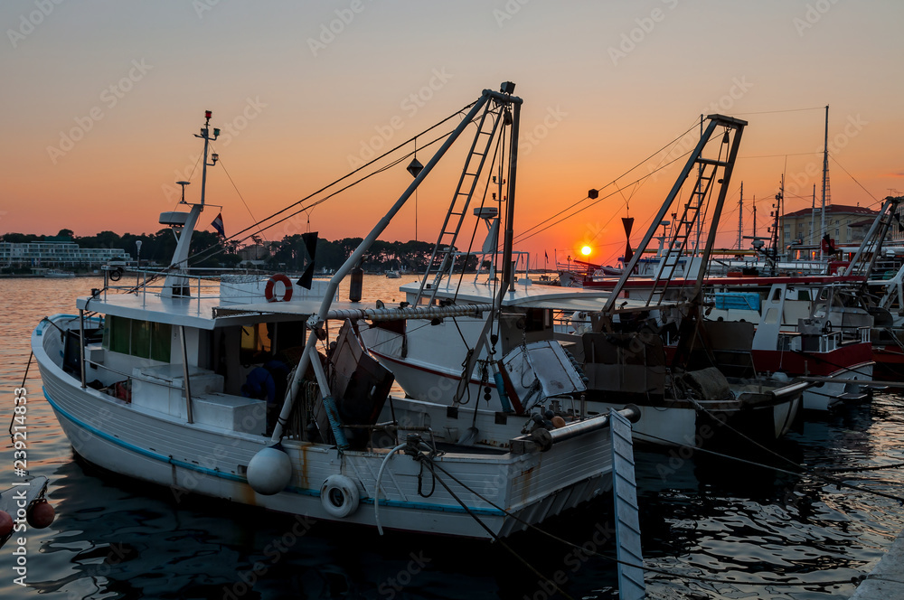 Fishing boats on sunset and calm sea. Istria region, Croatia