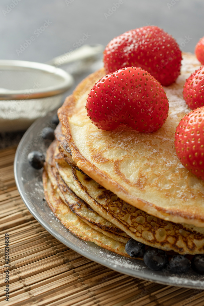Pancakes with strawberries on a plate. Sweet breakfast or snack. Pancakes with strawberries on a plate. Sweet breakfast or snack.