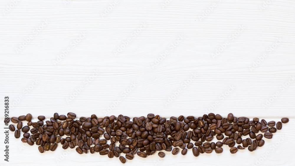 Part of frame roasted coffee beans down on white wooden background, top view. Copy space, free place for text Part of frame roasted coffee beans down on white wooden background, top view. Copy space, free place for text