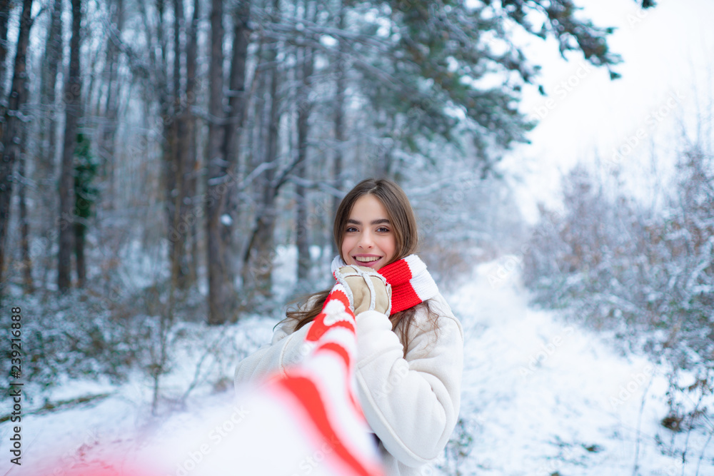 Outdoor portrait of young pretty beautiful woman in cold sunny winter weather in park.