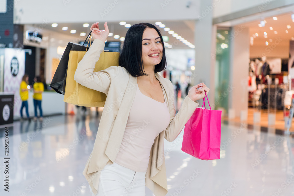 Portrait of beautiful young woman with shopping bags going out on a shopping spree.