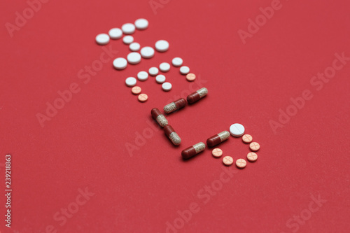 Inscription help formed of multi-colored pills